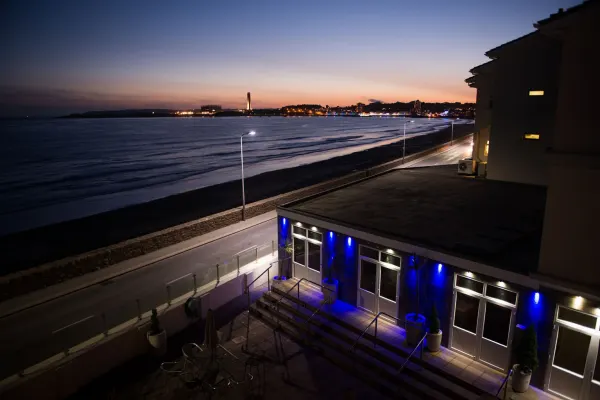 Exterior at dusk with sea view